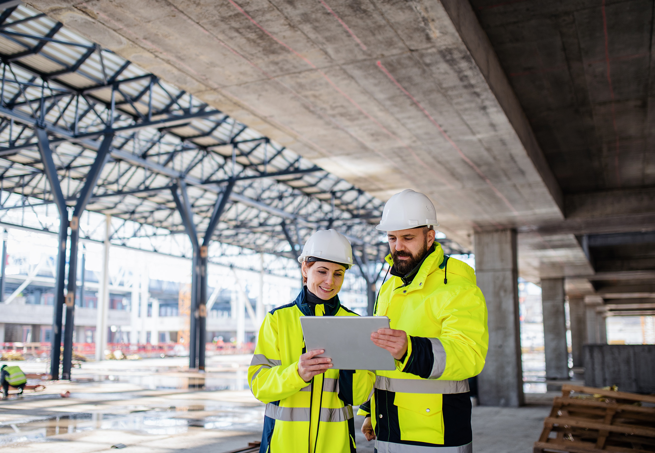 Construction site team reviewing project information on a tablet