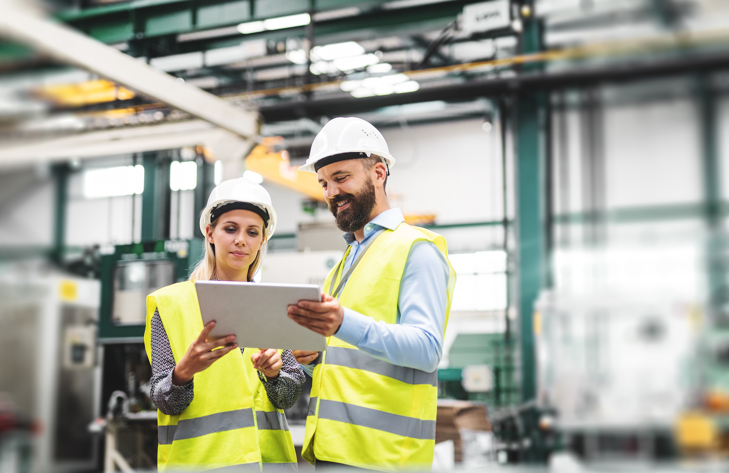 Manufacturing staff using digital systems on the factory floor