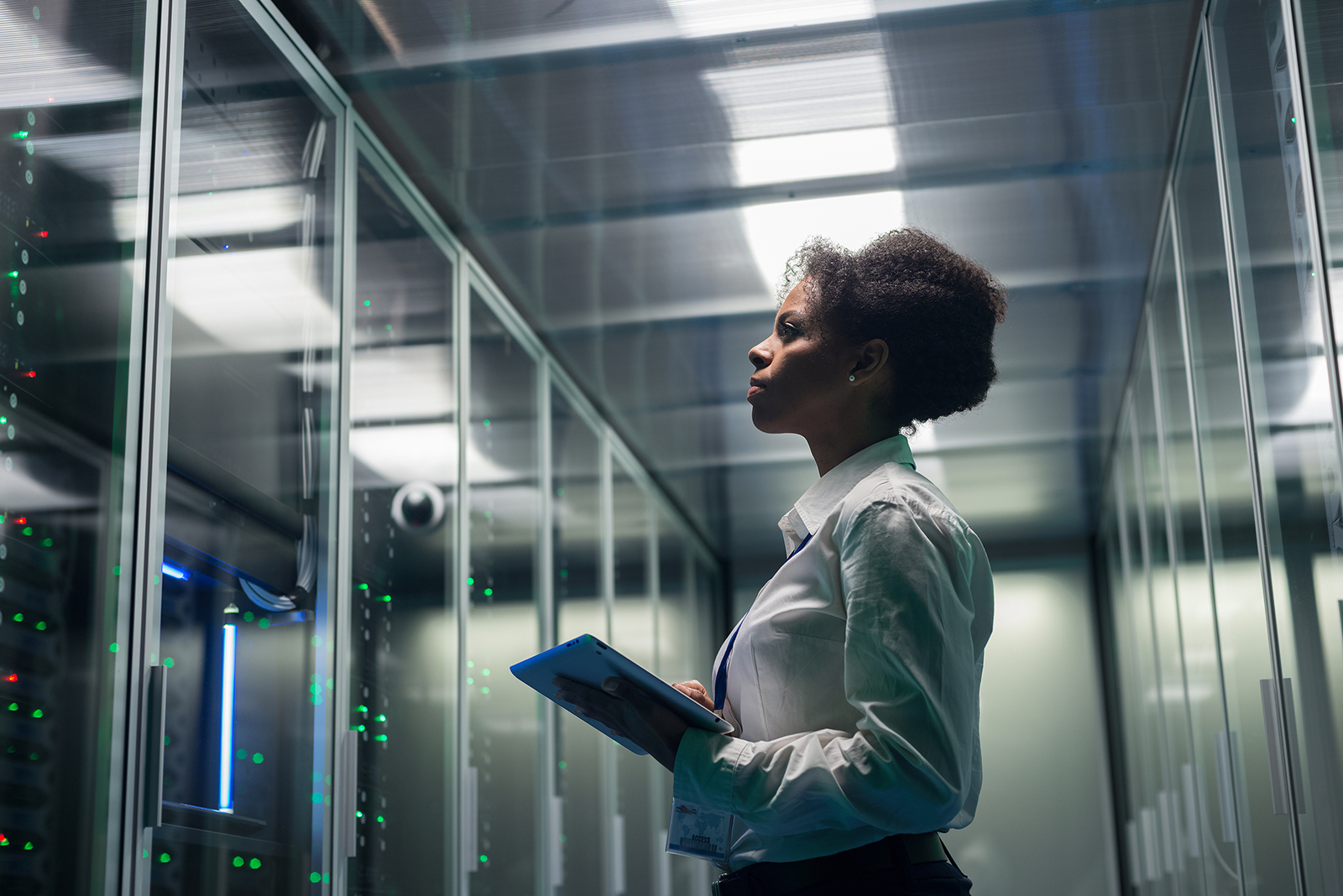 Female technician working securely on a tablet in a data centre